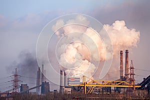 smoke stacks in a working factory emitting steam