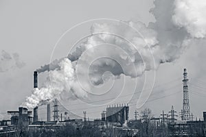 Smoke stacks in a working factory emitting steam