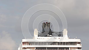 Smoke or steam exits from the cruise ship's smokestack before setting sail