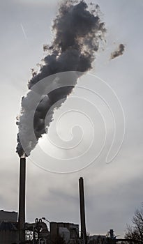 Smoke and steam spew from industrial smoke stacks near Amsterdam in the Netherlands