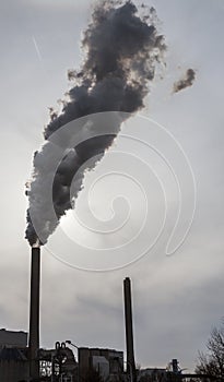 Smoke and steam spew from industrial smoke stacks near Amsterdam in the Netherlands photo