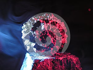 Smoke and an Unkown mineral in red and blue light on a turmalin mineral
