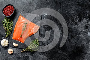 Smoked Atlantic salmon fillet. Organic fish. Black background. Top view. Copy space