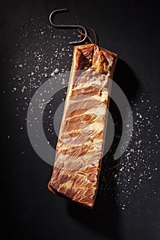 Smoked bacon over black background