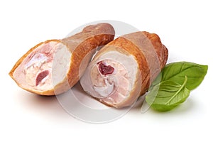 Smoked chicken legs with basil leaves, isolated on white background