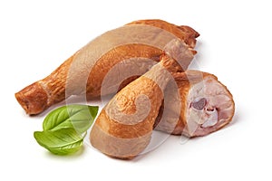 Smoked chicken legs with basil leaves, isolated on white background