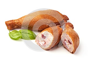 Smoked chicken legs with basil leaves, isolated on white background