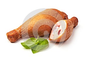 Smoked chicken legs with basil leaves, isolated on white background