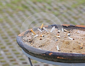 Smoked cigarettes in a dirty ashtray
