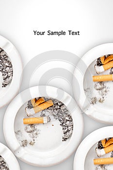 Smoked cigarettes in white ashtray