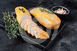 Smoked cut chicken breast fillet meat delicacy. Black background. Top view