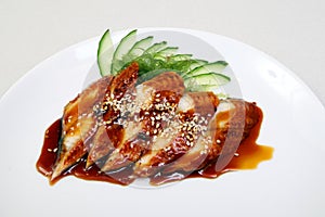Smoked eel with gravy and cucumber. Sashimi Unagi. Japanese food on a beautiful dish. Dietary food. An exquisite