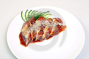 Smoked eel with gravy and cucumber. Sashimi Unagi. Japanese food on a beautiful dish. Dietary food. An exquisite