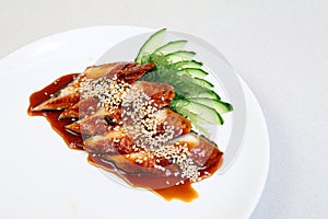 Smoked eel with gravy and cucumber. Sashimi Unagi. Japanese food on a beautiful dish. Dietary food. An exquisite