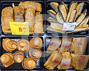 Smoked fillet trout, salmon, herring and mackerel on the delicacy counter in food supermarket
