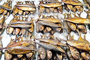 Smoked fish on the counter of a small farmers market. Products and food on the market in the fish store.