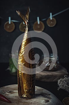 Smoked fish on the dark background