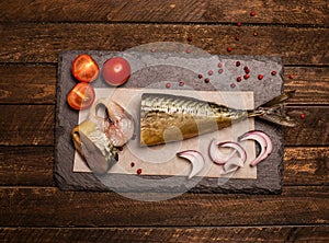 Smoked fish with onion, tomato and pepper. Food background.