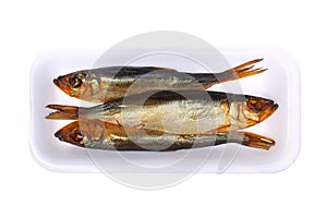 Smoked fish in the plastic plate, isolated