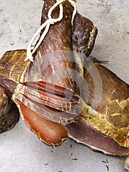 Smoked ham, jerky corned beef on table with garlic, herbs