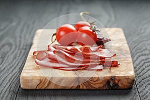 Smoked ham prsut with cherry tomatoes and chili