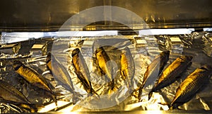 Smoked herring on foil in a display case