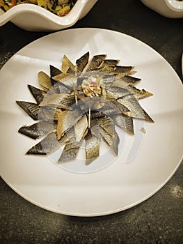 Smoked herring slices on a white plate in a restaurant