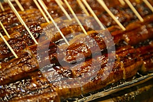 Smoked japanese eel in a market stall in Nishiki fish market in Kyoto, Japan.