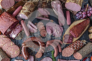 Smoked meat products. Display meats, cold cuts and sausages in a butcher`s shop photo