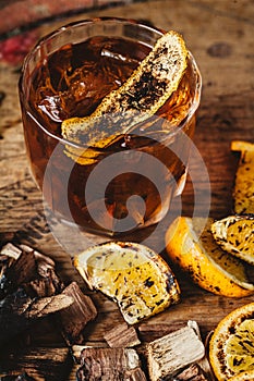 Smoked old fashioned cocktail on dark wooden background