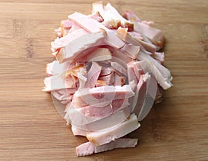 Smoked pork ham cut into strips on wooden background. Keto, carnivor, fat food diet concept