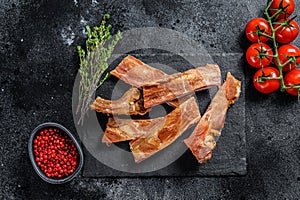 Smoked pork ribs. Barbeque spicy spareribs. BBQ food. Black background. Top view
