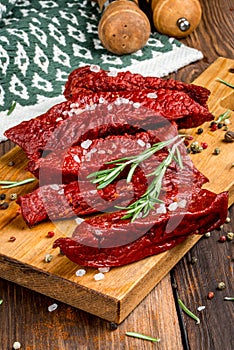 Smoked red deer maral filleted on a wooden background