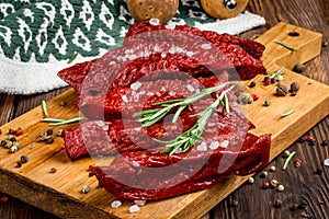 Smoked red deer maral filleted on a wooden background