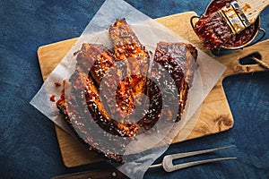 Smoked Roasted pork ribs over blue background. Barbeque spicy ri