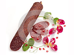 Smoked salami with flowers and pomegranate