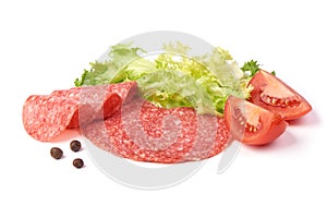 Smoked salami with green lettuce, tomatoes and spices, isolated on the white background