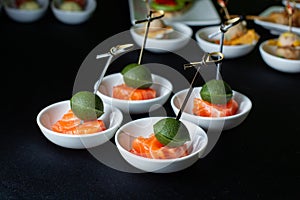 Smoked salmon canape with mousse, bonded with bamboo sticks.