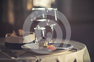 Smoked salmon with cheese, onion and herbs served on plate with glass of wine and toast, modern gastronomy