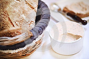 Smoked salmon cream spread in ramekin with bread loaf, appetizer