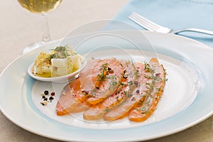 Smoked salmon and ingredients in plate on table