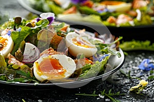 Smoked salmon and jammy soft-boiled free range egg and capers salad with edible borage and pansy flowers