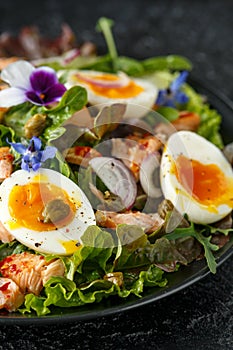 Smoked salmon and jammy soft-boiled free range egg and capers salad with edible borage and pansy flowers