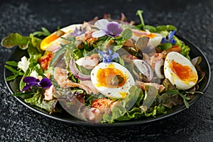 Smoked salmon and jammy soft-boiled free range egg and capers salad with edible borage and pansy flowers