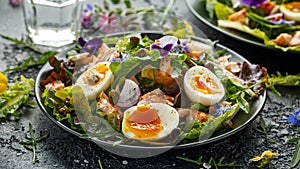 Smoked salmon and jammy soft-boiled free range egg and capers salad with edible borage and pansy flowers