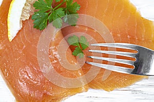 Smoked salmon with parsley solated on white background photo