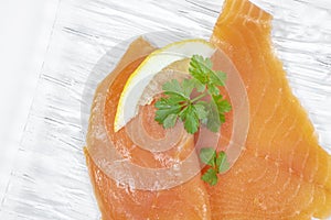 Smoked salmon with parsley solated on white background photo
