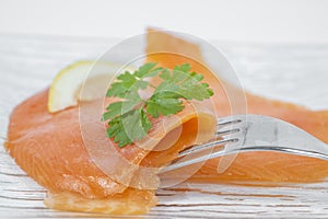 Smoked salmon with parsley solated on white background photo