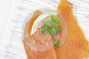 Smoked salmon with parsley solated on white background