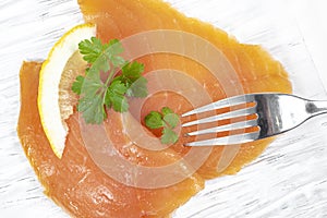 Smoked salmon with parsley solated on white background photo